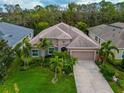 Charming single-Gathering home with a well-manicured lawn, lush landscaping, and a spacious driveway at 854 Rosemary Cir, Bradenton, FL 34212