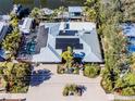 Aerial view of single-Gathering home with pool and solar panels at 903 20Th W Ave, Palmetto, FL 34221