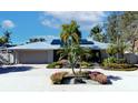 House exterior featuring a metal roof, solar panels, and landscaped yard at 903 20Th W Ave, Palmetto, FL 34221