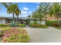 Home exterior showcasing landscaping and a paver driveway at 903 20Th W Ave, Palmetto, FL 34221