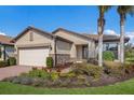 One-story home with a two-car garage, neatly landscaped yard, and palm trees at 11136 Shearwater Ct, Sarasota, FL 34238