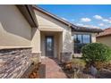 Attractive front entry with stone accents and a paved walkway at 11136 Shearwater Ct, Sarasota, FL 34238