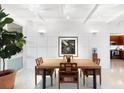 Bright dining room with a large wooden table and mid-century chairs at 117 S Polk Dr, Sarasota, FL 34236