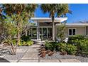 Landscaped walkway leading to mid-century modern home at 117 S Polk Dr, Sarasota, FL 34236