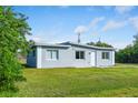 Newly built home with a contemporary design, featuring light gray siding and a grassy yard at 1226 Coral Ridge Dr, Punta Gorda, FL 33950