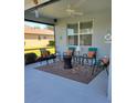 Relaxing screened patio with seating and decorative rug at 12904 49Th E Ln, Parrish, FL 34219