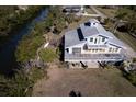 Elevated home on waterfront lot with large deck and private backyard at 145 Burns Rd, Terra Ceia, FL 34250