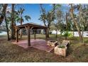 Backyard with gazebo, fire pit, and wooden seating at 14802 7Th E Ave, Bradenton, FL 34212