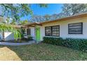 House exterior with a green door and landscaping at 1625 Bravo Dr, Clearwater, FL 33764