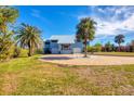 House exterior showcasing a metal roof and paver driveway at 1649 Manor Rd, Englewood, FL 34223