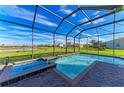 Relaxing pool and spa with screened enclosure overlooking the landscape at 16625 5Th E Ave, Bradenton, FL 34212