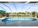 Relaxing kidney-shaped pool with a screened enclosure at 170 Bonita Dr, Rotonda West, FL 33947