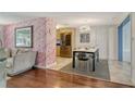 Modern dining area with stainless steel appliances, stylish chairs, and flamingo wallpaper at 1705 Shoreland Dr, Sarasota, FL 34239