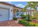 Inviting front porch with rocking chairs and nicely landscaped yard at 17722 Littleton Pl, Lakewood Ranch, FL 34202