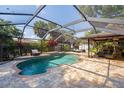 Inviting screened pool area with a patio and lounge chairs at 180 Aurora Rd, Venice, FL 34293