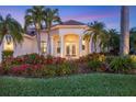 Elegant home exterior featuring a grand entrance and lush landscaping at 2037 Silver Palm Rd, North Port, FL 34288