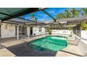 Inviting kidney-shaped pool with screened enclosure and patio at 211 84Th St, Holmes Beach, FL 34217