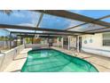 Refreshing kidney-shaped pool with a screened patio cover at 211 84Th St, Holmes Beach, FL 34217