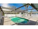 Relaxing kidney-shaped pool with a screened patio cover at 211 84Th St, Holmes Beach, FL 34217