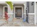 Townhome entry with dark brown door, stone accents, and ADT security system at 2850 Midnight Pearl Dr, Sarasota, FL 34240