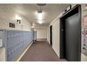 Building hallway with mailboxes and elevator access at 315 30Th W Ave # B210, Bradenton, FL 34205