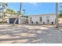 Inviting exterior view of a home showcasing a circular driveway, tidy landscaping, and a welcoming facade at 320 Avenida Leona, Sarasota, FL 34242