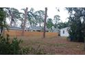 View of the backyard, showing a wooden fence separating it from a neighboring property at 3218 Avenue A W, Bradenton, FL 34205