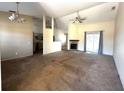 Spacious living room featuring a fan, a fireplace, and access to the outdoors at 3409 Branch Creek Dr, Sarasota, FL 34235