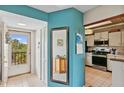 Bright condo entryway with mirror and partial kitchen view at 3620 Ironwood Cir # 405, Bradenton, FL 34209