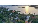 Waterfront property aerial view showcasing home and sunset at 3950 Red Rock Way, Sarasota, FL 34231