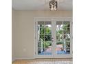 Glass French doors open to a view of the backyard patio at 4563 Trails Dr, Sarasota, FL 34232