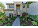 Front entry with stone accents, landscaping, and a walkway at 4852 Coastal Days Ln, Bradenton, FL 34211