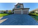 Two-car garage with gray doors and a paved driveway at 4852 Coastal Days Ln, Bradenton, FL 34211