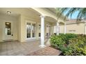 Outdoor patio with columns, tile flooring, and access from multiple doors at 5781 Girona Pl, Sarasota, FL 34238