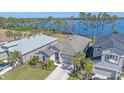 Two homes showcased in an aerial view, one with a lake view and landscaped yard at 6347 Grandview Hill Ct, Bradenton, FL 34203