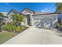 Single-story home with a two-car garage, landscaping and a driveway at 6347 Grandview Hill Ct, Bradenton, FL 34203