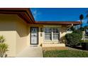 House exterior featuring a security door and landscaped grounds at 6405 Auburn Ave # 8, Bradenton, FL 34207