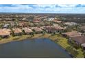 Aerial view of a large community with many homes and a lake at 6730 Haverhill Ct, Bradenton, FL 34202