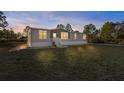 Single-story home with light gray siding, white trim, and a front porch at 7041 Alan Blvd, Punta Gorda, FL 33982