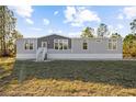 Single-story manufactured home with light gray siding and a white base at 7041 Alan Blvd, Punta Gorda, FL 33982