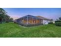 Backyard view of the home with a screened-in pool at 7412 Links Ct, Sarasota, FL 34243