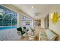 Covered patio featuring a seating area with a ceiling fan at 7412 Links Ct, Sarasota, FL 34243