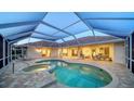 Screened-in pool area with a spa and plenty of lounge space at 7412 Links Ct, Sarasota, FL 34243