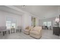 Bright living room with light flooring and comfy seating at 750 N Tamiami Trl # 314, Sarasota, FL 34236