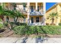 Front view of townhouse with lush landscaping and private entrance at 7879 Bergamo Ave, Sarasota, FL 34238