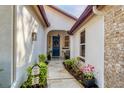 Inviting walkway leading to a charming blue front door at 804 Connemara Cir, Venice, FL 34292