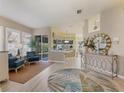 Bright and airy living room with stylish furniture and large windows at 804 Connemara Cir, Venice, FL 34292