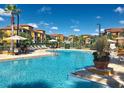 Resort-style pool with plenty of lounge chairs and umbrellas at 8335 38Th Street E Cir # 303, Sarasota, FL 34243