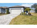 New home exterior with paver driveway and landscaping at 9405 Ballaster Pointe Loop, Parrish, FL 34219