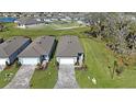 New construction home boasts a paver driveway, attached two-car garage and lush green lawn at 9405 Ballaster Pointe Loop, Parrish, FL 34219